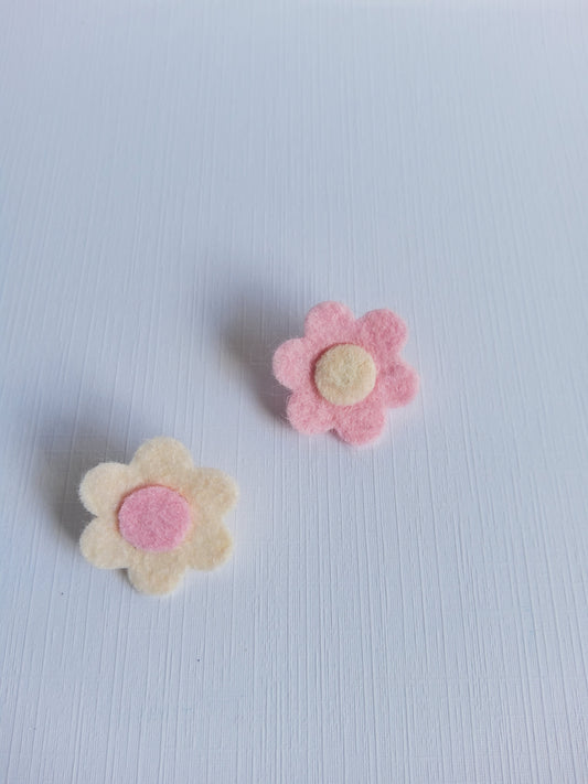 Two felt flower shapes on a white background