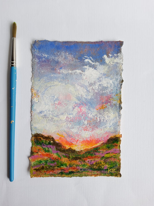 Abstract painting on a textured surface with a blue paintbrush below