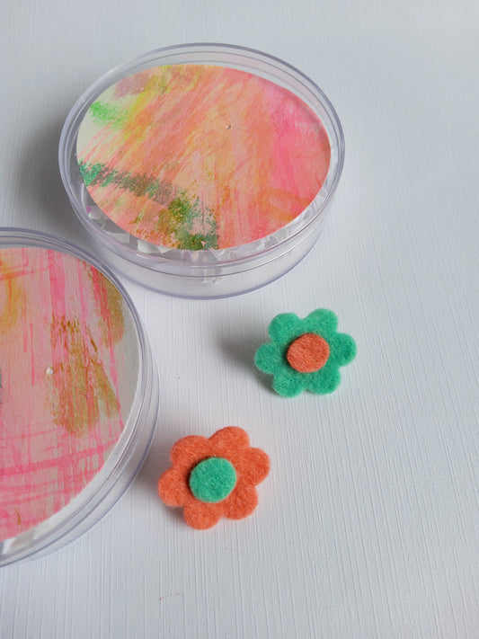 Felt flower pins on a white background