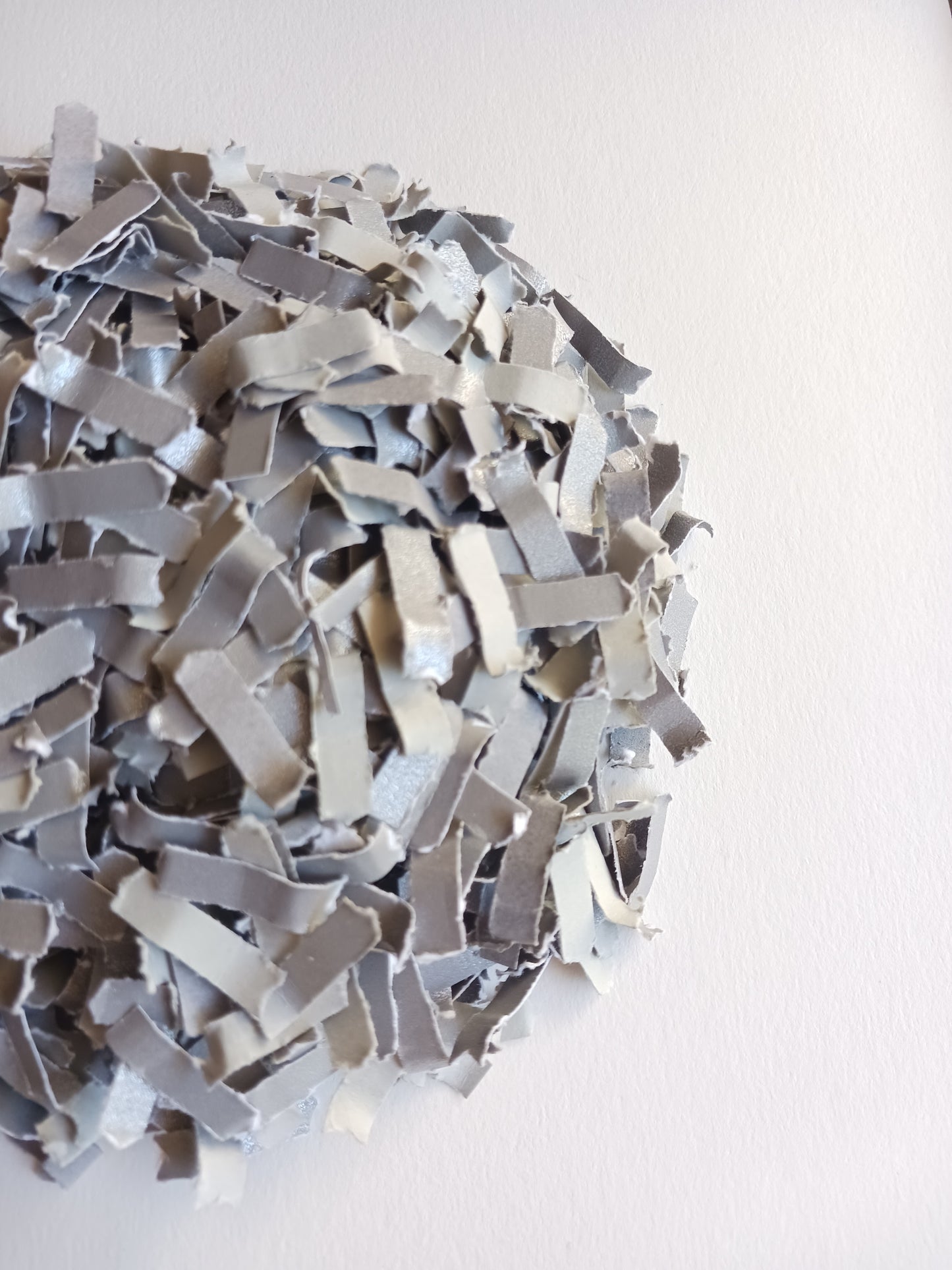 Silver grey confetti close-up shot on white background. 