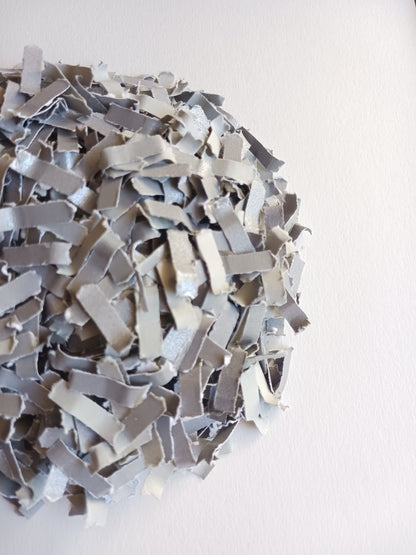 Silver grey confetti close-up shot on white background. 