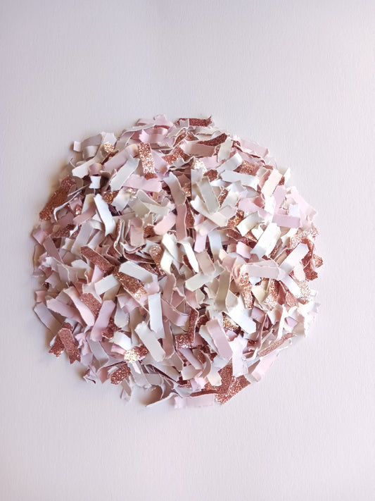 Rose gold, pink and white confetti on a white background