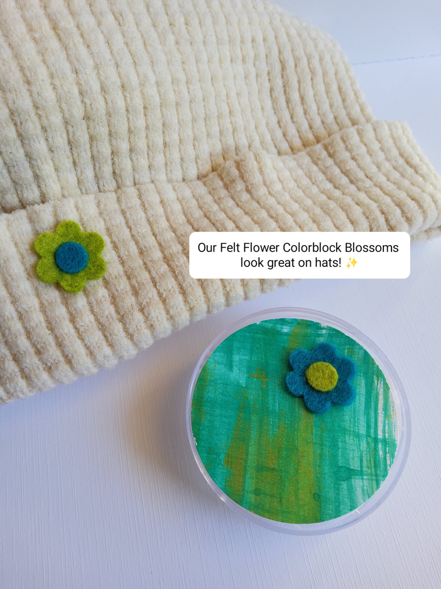 Felt flower colorblock blossoms displayed on a knit hat as an example, with text overlay.