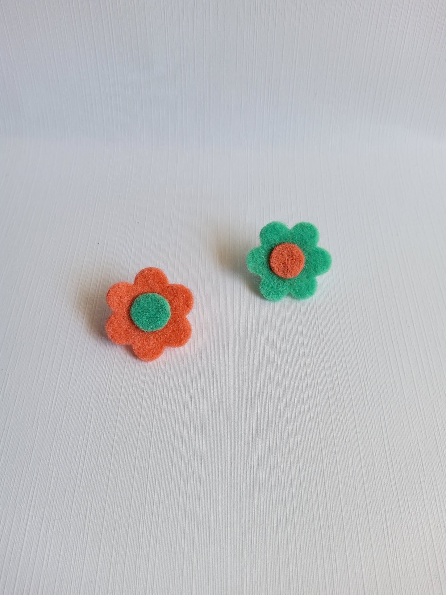 Two felt flower pins on a white background 