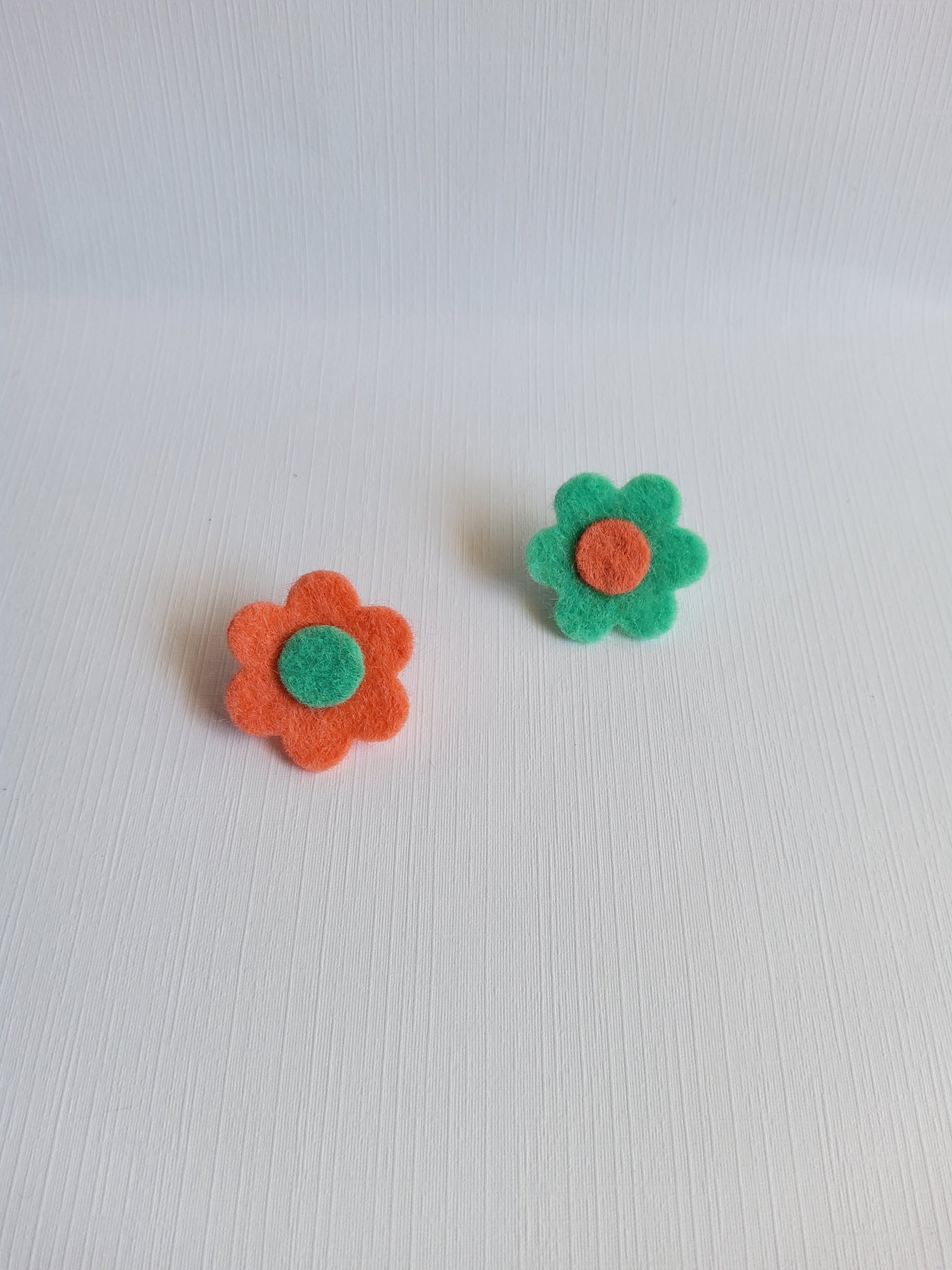 Two felt flower pins on a white background 