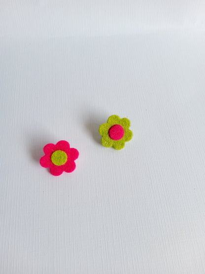 Two felt flower pins on a white background