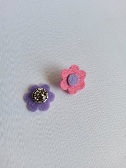 Flower-shaped pins on a light gray background