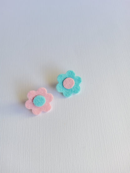 Two felt flower pins on a light gray background