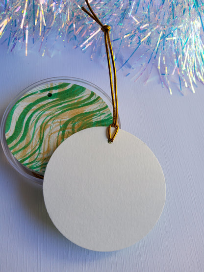 Green and gold  abstract hand-painted round gift tags with gold cords and iridescent tinsel background