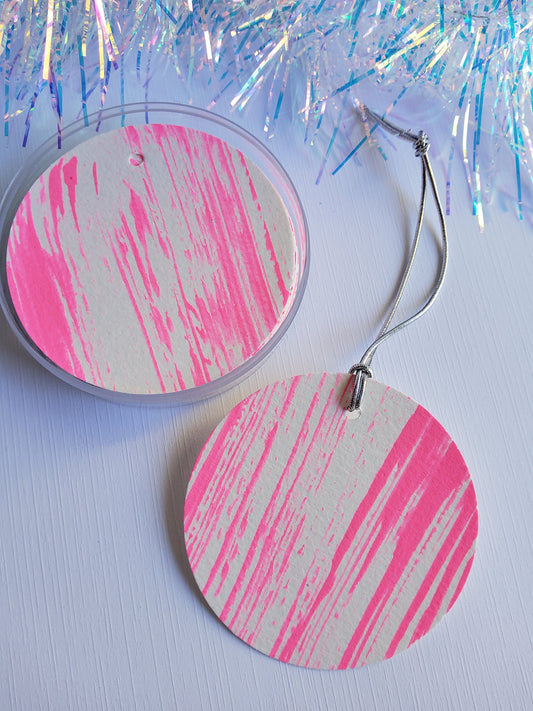 Set of hand-painted abstract gift tags with silver stretch cords displayed beside iridescent tinsel 