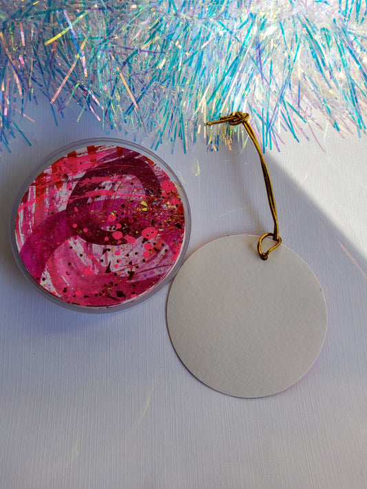 Red,pink and gold glitter abstract hand-painted round gift tags with gold cords and iridescent tinsel background