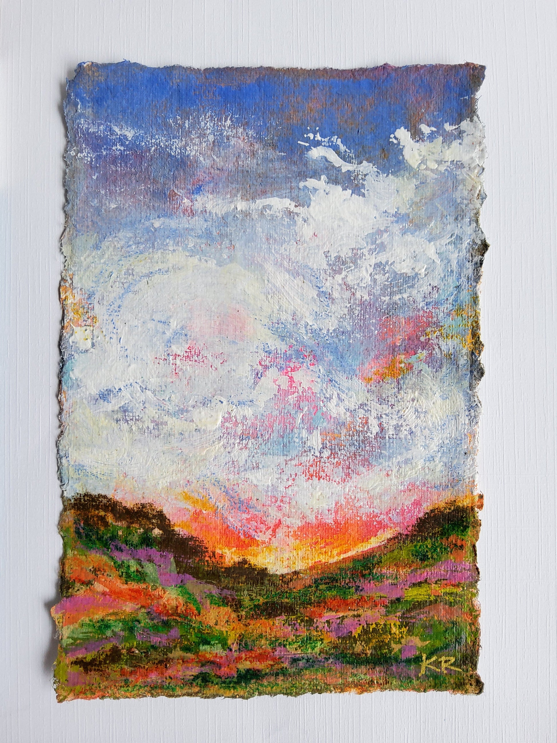 Vertical acrylic landscape with clouds, sunset tones, and deckle-edged handmade paper