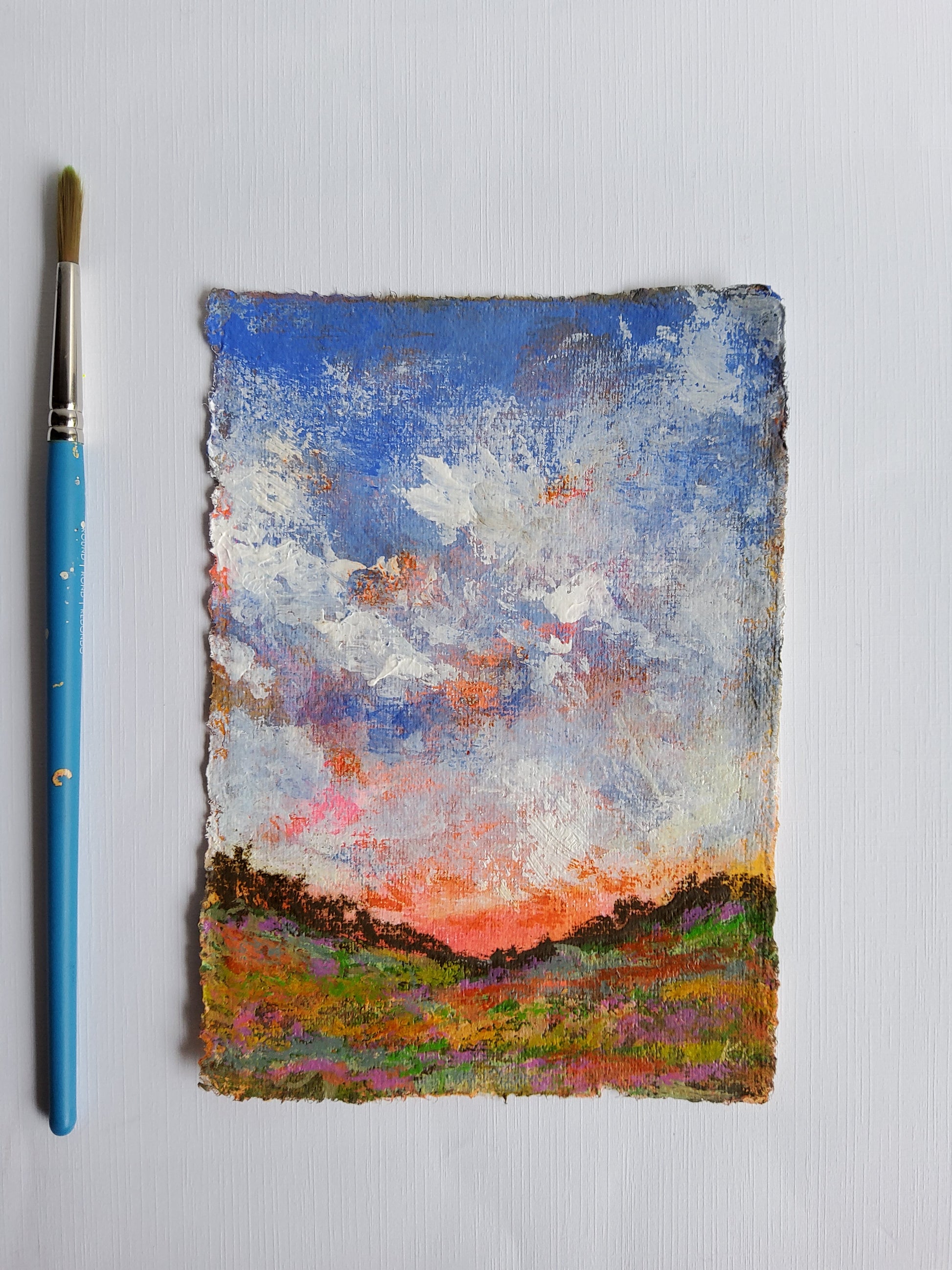 Small abstract painting with a brush on a light gray background