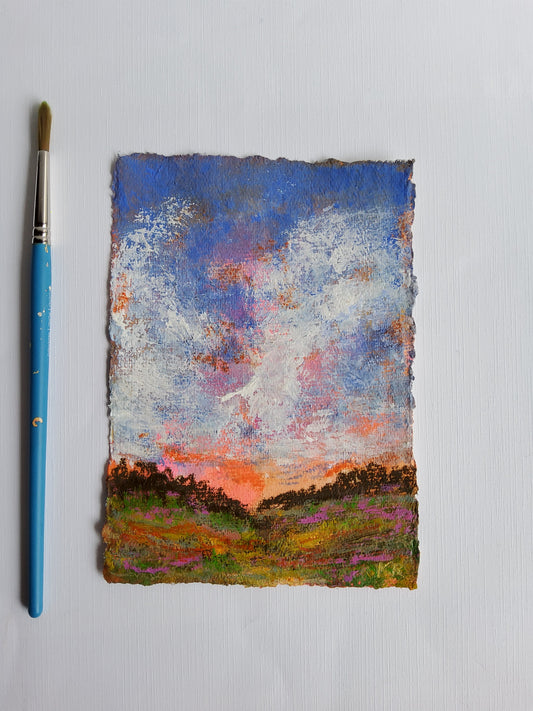 Abstract painting on a textured surface with a paintbrush below